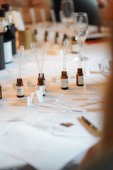 Small brown glass bottles with pipettes and labels on a table used for perfume creation or...