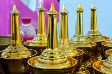 Golden water bottle for poring water for pray to dead people in Thailand culture.
