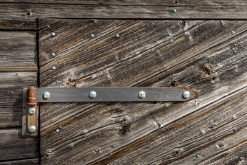 Old wooden door with an old iron hinge