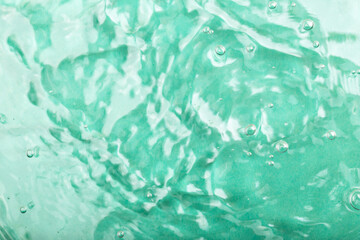Turquoise water background. Turquoise water surface features gentle ripples and bubbles, creating tranquil aquatic ambiance, showcasing beauty of water movement and light reflections in environment