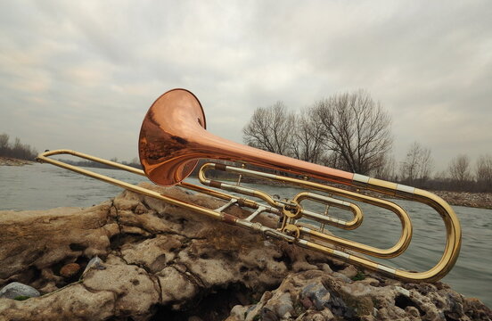 Bass trombone on rock on Adda river, Italy