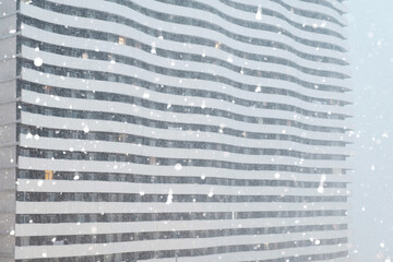Heavy snowing winter view of skyscraper facade