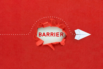 Concept of overcoming barriers, goal, target. White paper plane on red background