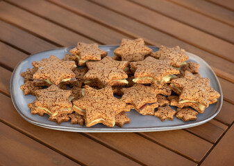 Homemade Gluten-Free Star Cookies on Long Platter with Pistachio Cream and Fruit Jam Filling