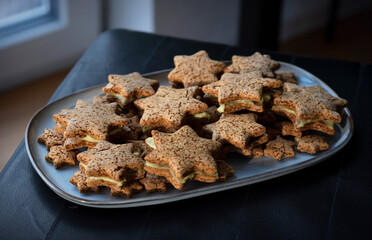 Homemade Gluten-Free Star Cookies on Long Platter with Pistachio Cream and Fruit Jam Filling
