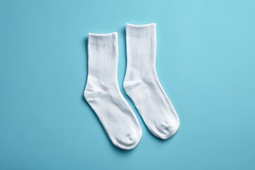 Pair of Clean White Cotton Socks on Light Blue Background