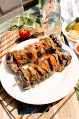 Grilled liver with assorted vegetables, picnic outdoors, sunny summer brunch