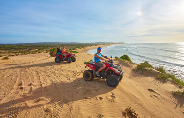 A group of tourists enjoys quad biking along Essaouira's oceanfront © Ryzhkov Oleksandr