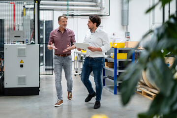 Business colleagues planning with each other in factory
