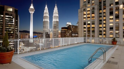 Beautiful rooftop pool overlooking Kuala Lumpur skyline with iconic twin towers during evening twilight