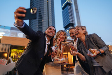 Business People Taking Selfie While Eating Street Food in Milan, Italy