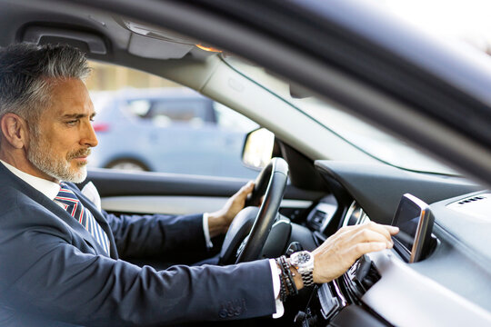 Businessman using GPS sitting in car