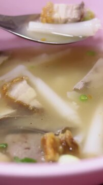 Eating Rolled Rice Noodle Soup With Crispy Pork in Bangkok