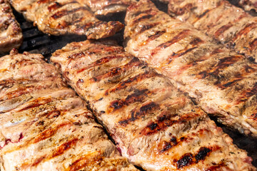 A close up of seasoned pork ribs on a barbecue grill, Grilled Meat