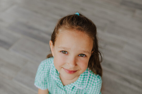 Naklejki Portrait of smiling child in school uniform looking at camera