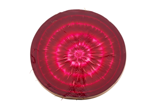 A close-up view of a vibrant, deep red beetroot slice, showcasing its intricate concentric circles and a rich internal structure against a pure black background.