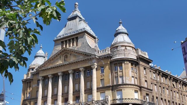 Pan-down of Anker Palota in Budapest, highlighting its elegant neoclassical facade, intricate details, and architectural design