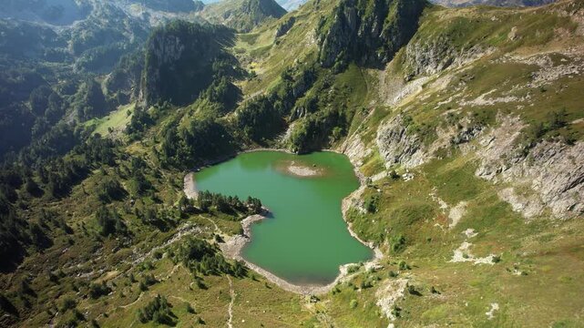 Aerial views of an alpine lake in the french Pyrenees at low altitude