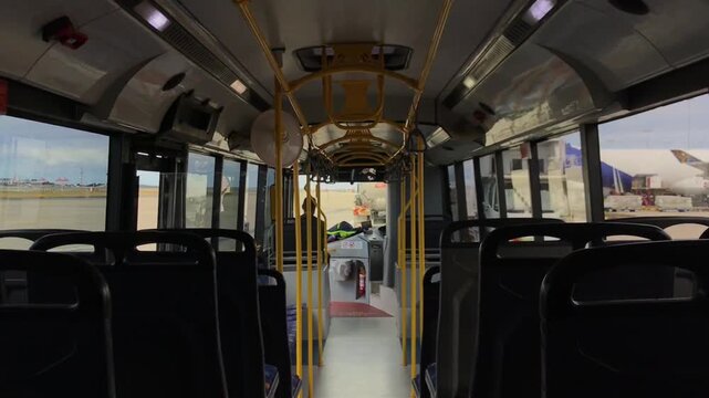 Airport bus traversing empty tarmac at Kingsford Smith Airport, SYD terminal in Sydney, Australia, moving without passengers during quiet moment of airport operations