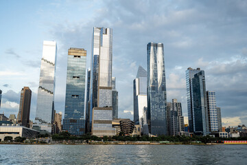 Obraz premium Hudson Yards skyline with modern towers in Manhattan. Tall glass skyscrapers of Hudson Yards dominate Manhattan skyline on clear day.