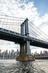 Obraz premium Manhattan Bridge with steel towers and cables. Iconic Manhattan Bridge with steel towers and suspension cables in daylight view.
