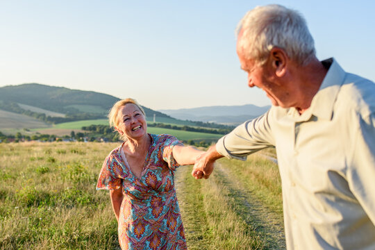 Elderly man and woman spending time in nature.