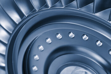 close up of a turbine blade with many small holes. blade is silver and has a shiny appearance blue tone © Aleksandr Matveev