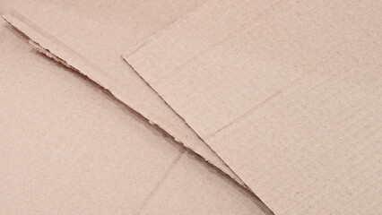 Stack of cardboard boxes with a white background. The boxes are cut in half and have a rough texture
