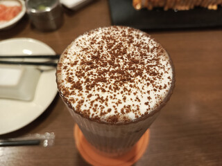 A Cozy Moment: High-Angle View of a Frothy Drink Dusted with Cocoa Powder