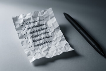 Completed To-Do List on Wrinkled Paper with Pen