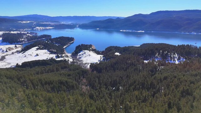 Aerial winter view of Dospat Reservoir at sunset, Smolyan Region, Bulgaria