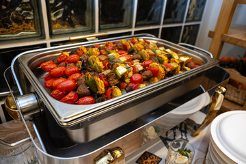Grilled vegetable skewers with corn mushrooms and peppers in metal tray