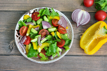 Fresh and Colorful Salad with Tomatoes, red Onions, cucumber and Peppers