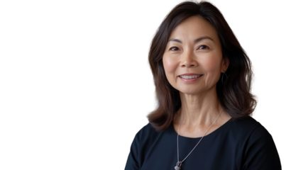 Professional woman with long hair smiling confidently, wearing a black top and silver necklace against a neutral background in corporate setting