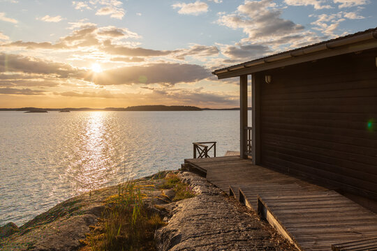 Amazing golden sunset over the Turku archipelago in south east Finland with a view on a typical swimming jetty which are everywhere on the many islands for locals to enjoy the Balic sea after a sauna