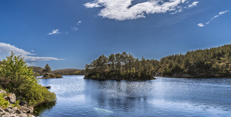 Peaceful Lake Scene with Forested Island and Clear Blue Sky. Bomlo, Norway