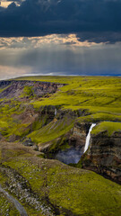 Aerial View of Waterfall and Moss Covered Terrain in Iceland