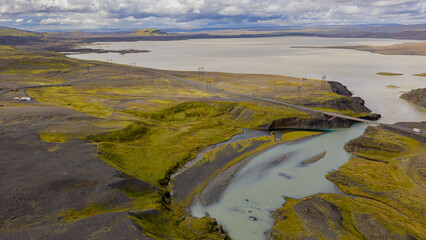 Aerial View of Icelandic River, Volcanic Terrain, and Distant Lake