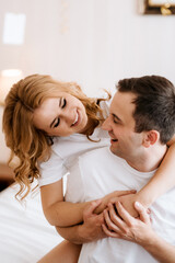 Fototapeta premium young couple bride and groom in the morning in a hotel room