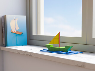 Sailboat model made of building blocks on a window sill at home