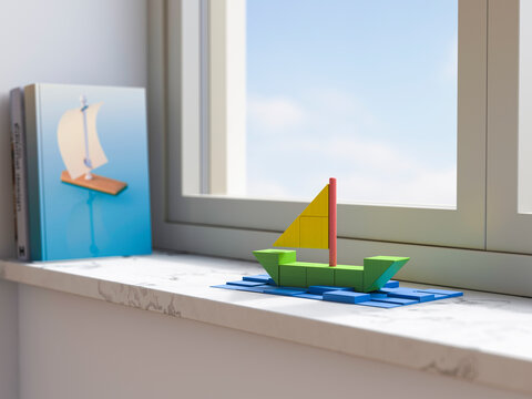 Sailboat model made of building blocks on a window sill at home