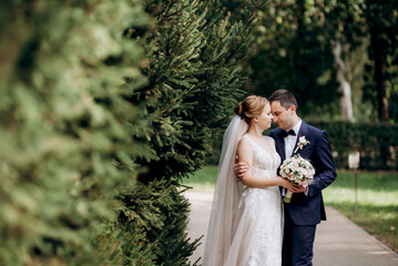 bride and groom walking in the park