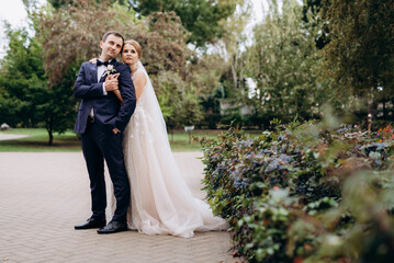 bride and groom walking in the park