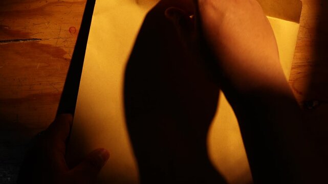 Close-up of someone opening the document that contains a security document that has been marked FAKE with a red stamp.