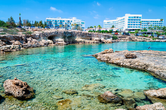 Bay with turquoise water on Cypriot beach in popular holiday resort, Nisia Loumbardi, Paralimni, Cape Greco, Cyprus. The most beautiful places Cyprus.	
