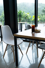 Modern Cafe Table with Coffee and Pastry Near Window