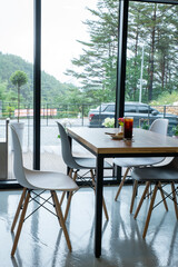 Modern Cafe Table with Coffee and Pastry Near Window
