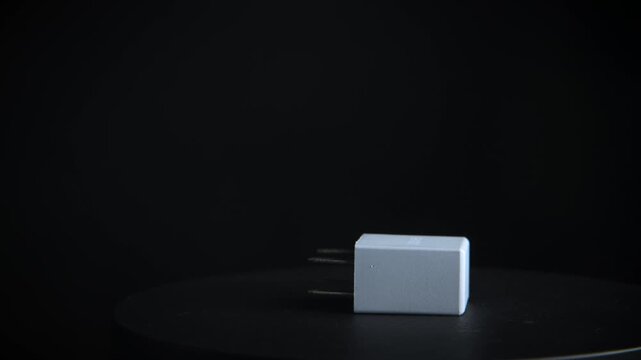 Close up of grey car relay rotating on black background