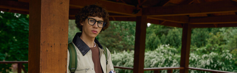 Fototapeta premium Young man enjoying a peaceful outdoor walk in a serene natural setting on a sunny day