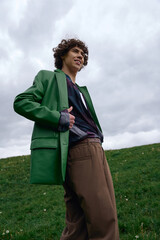 Young handsome student enjoys a refreshing stroll outdoors under cloudy skies